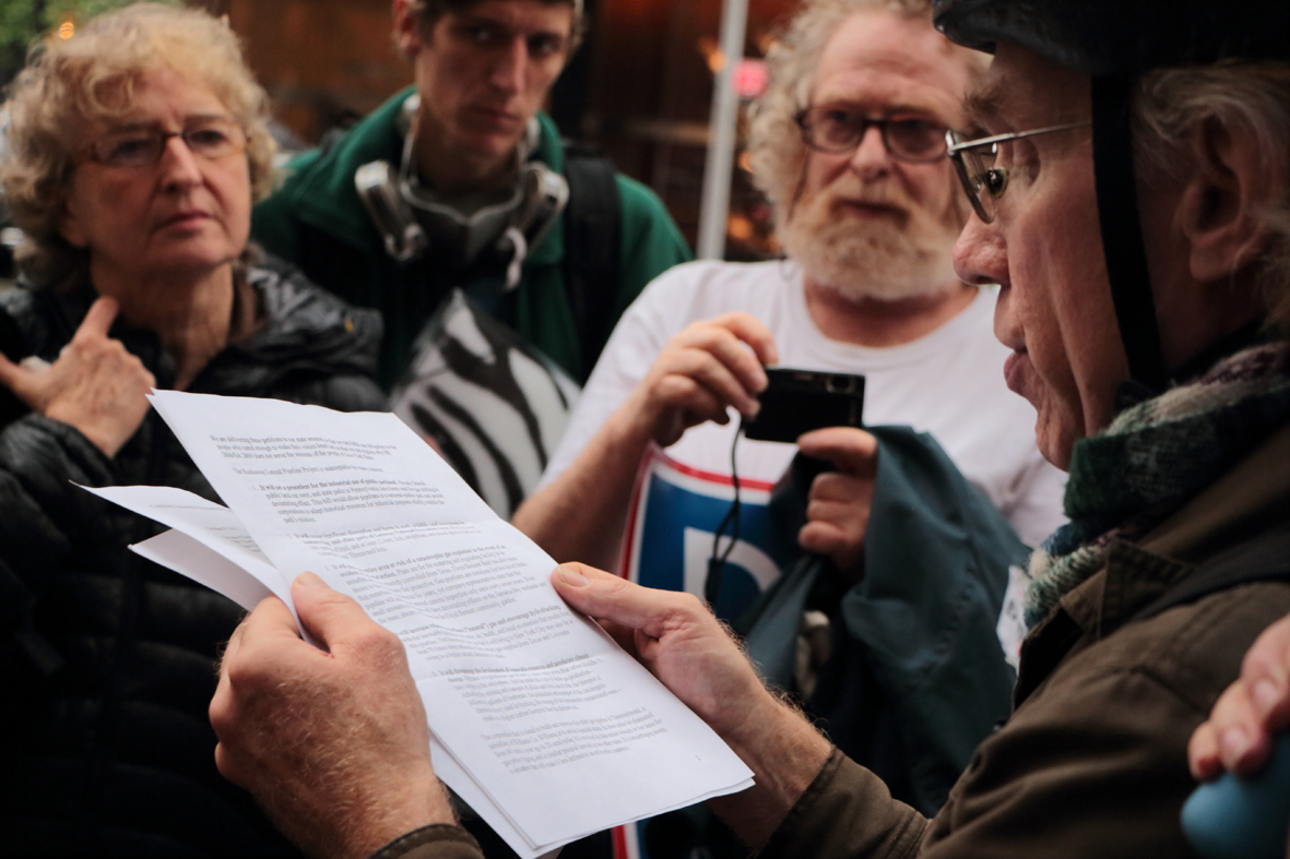 IMG_1598 Jonathan Fluck from the Coalition Against the Rockaway Pipeline reads out a letter to Senator Charles Schumer to demonstrators.